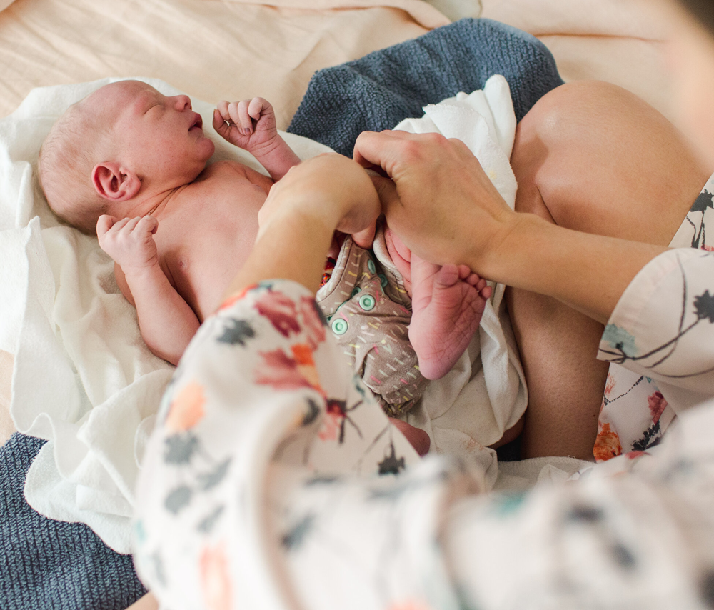 Person changes infant's diaper