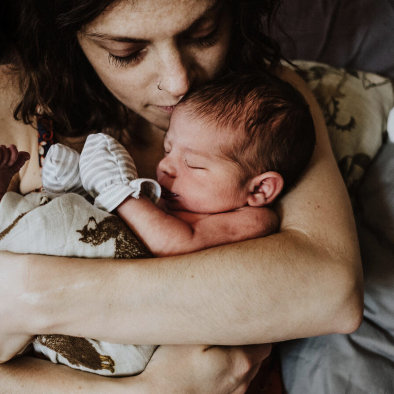 Person holds infant tightly