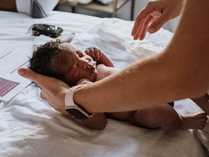 Birth assistant supports infant's head