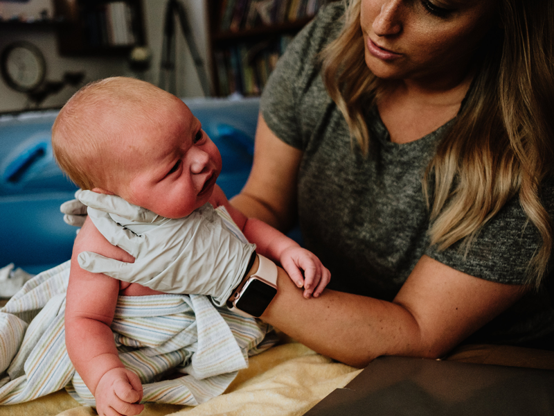 Birth assistant supports infant's head