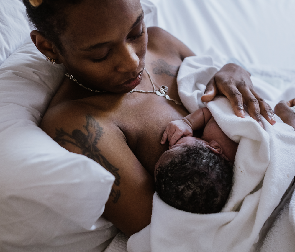 Person breastfeeds newborn
