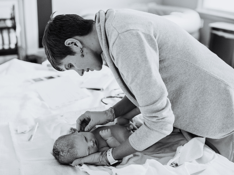 Midwife checks newborn
